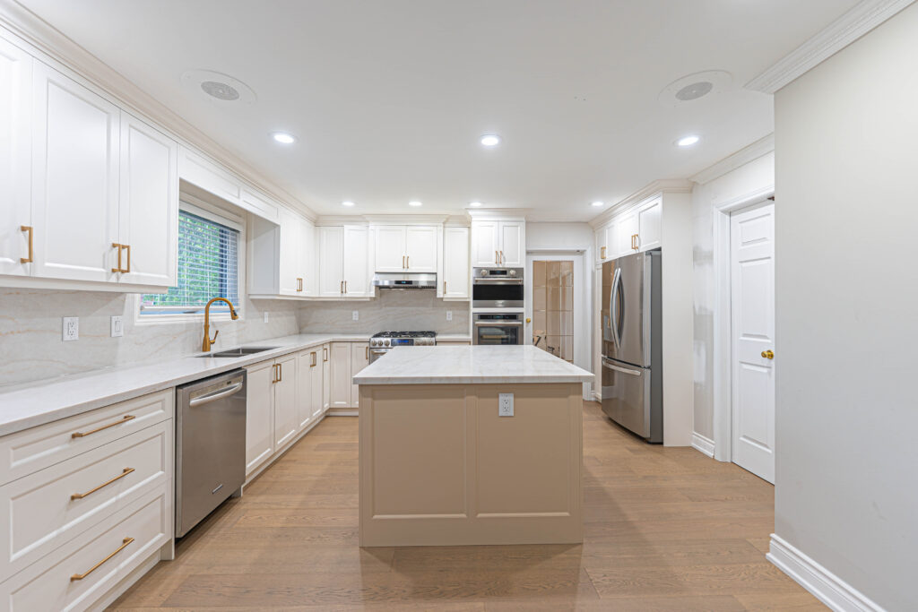 White kitchen with an island in Oakville